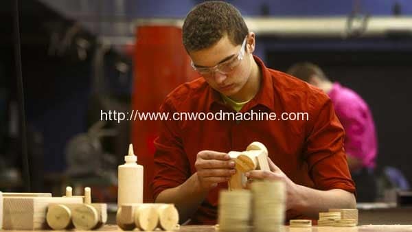 Thompson high school students present wooden toys to first-graders